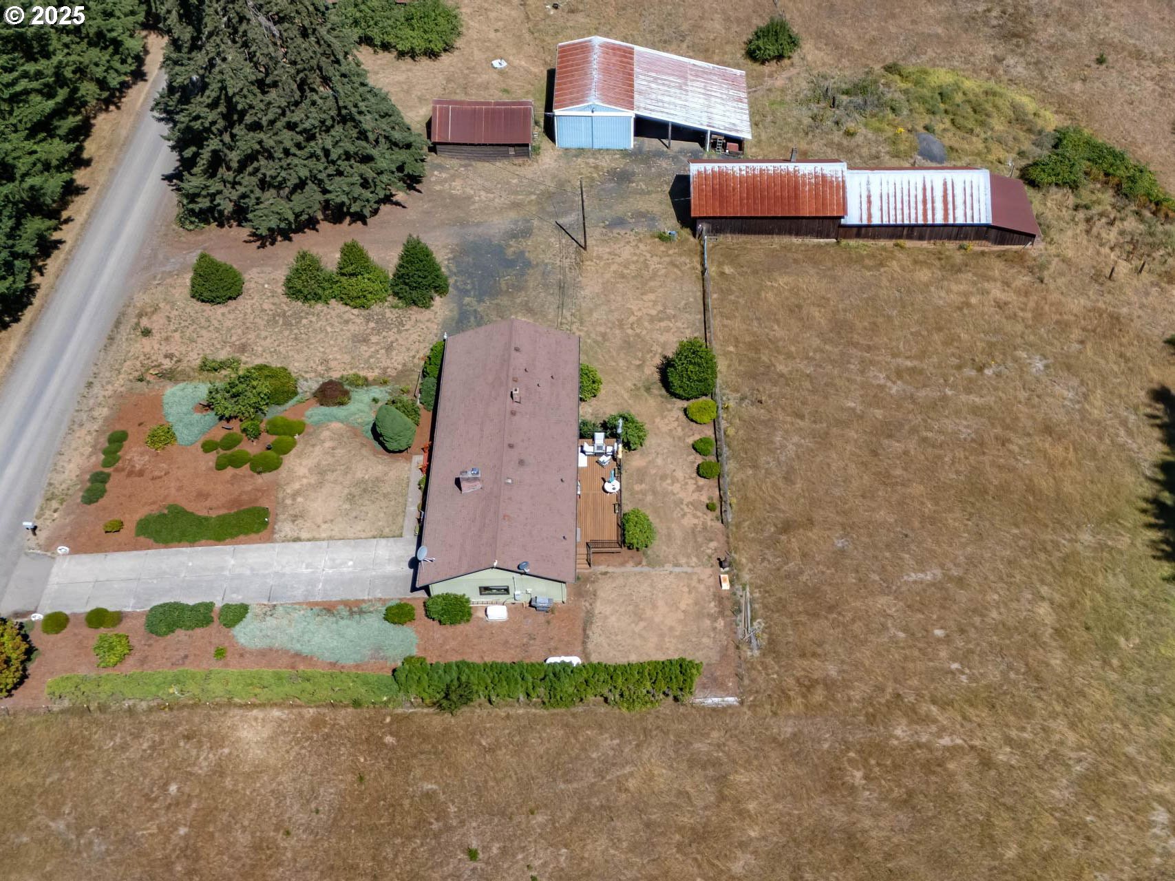 25420 Northwest Pumpkin Ridge Road North Plains, OR 97133 - Photo 26 of 41 an aerial view of a house with a yard and a large tree