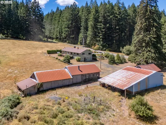 a wooden bench sitting in the middle of a yard