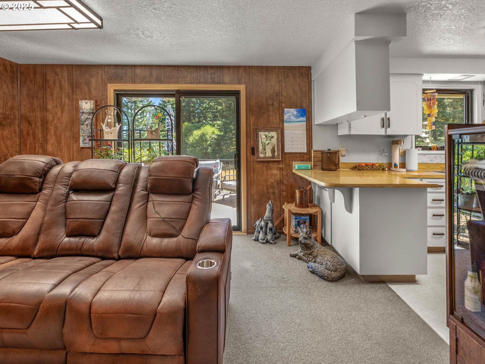 25420 Northwest Pumpkin Ridge Road North Plains, OR 97133 - Photo 5 of 41 a living room with furniture and a large window