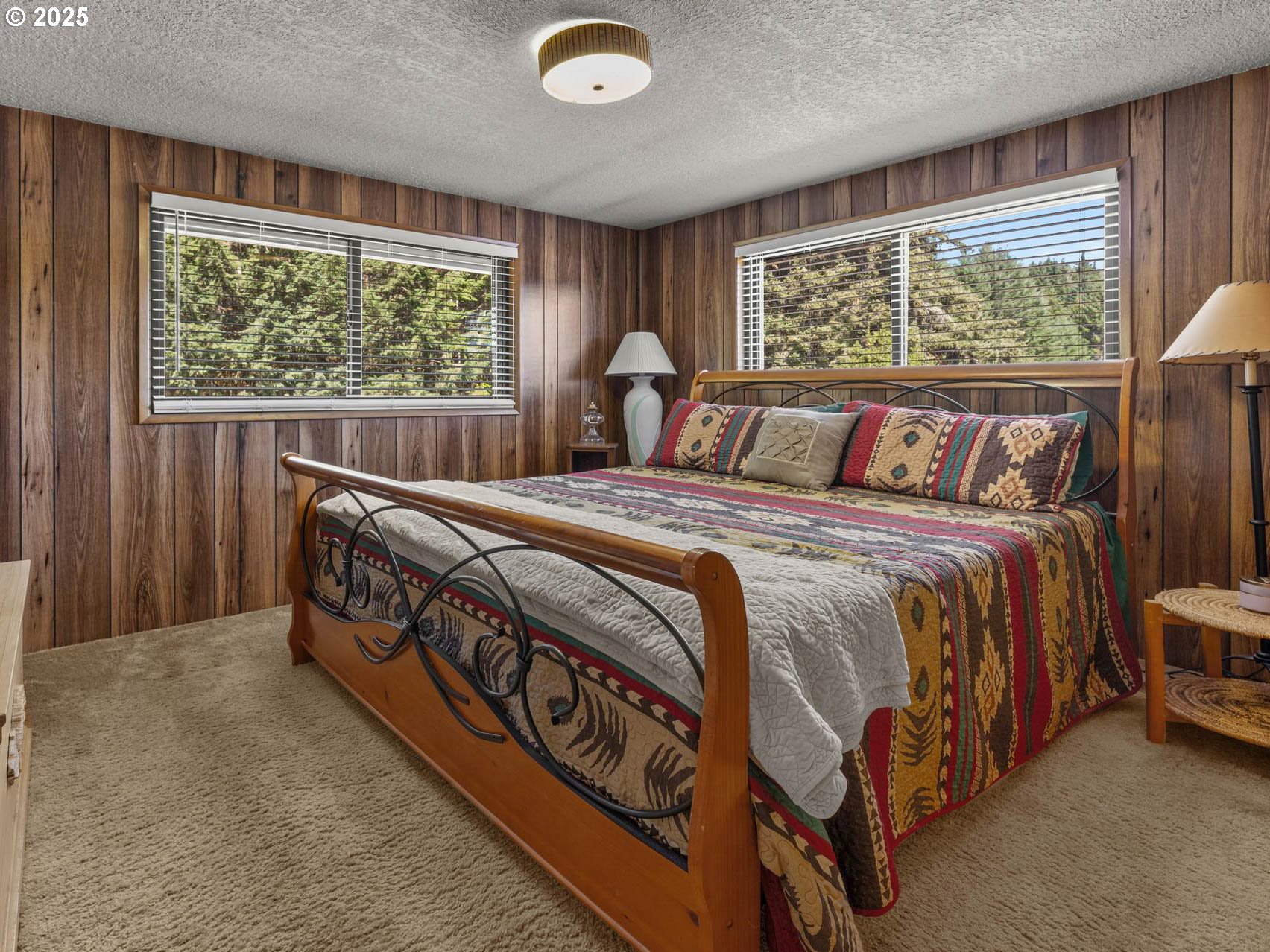 25420 Northwest Pumpkin Ridge Road North Plains, OR 97133 - Photo 8 of 41 a bed sitting in a bedroom next to a window