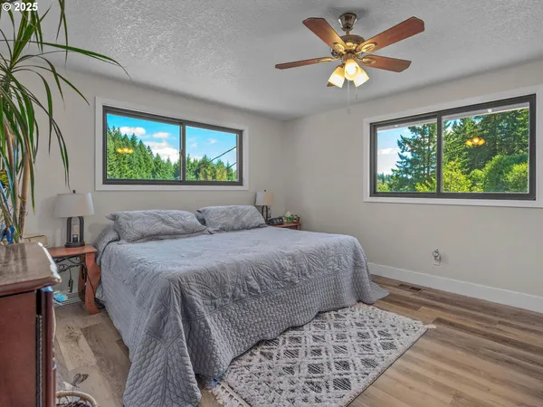 a bed sitting in a bedroom next to a window