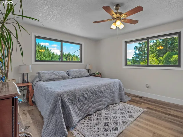 a bed sitting in a bedroom next to a window