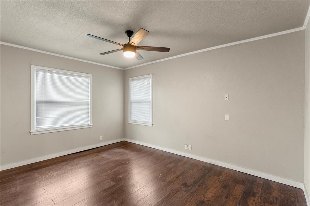714 Jeanell Street Quitman, TX 75783 - Photo 16 of 20 an empty room with wooden floor fan and windows