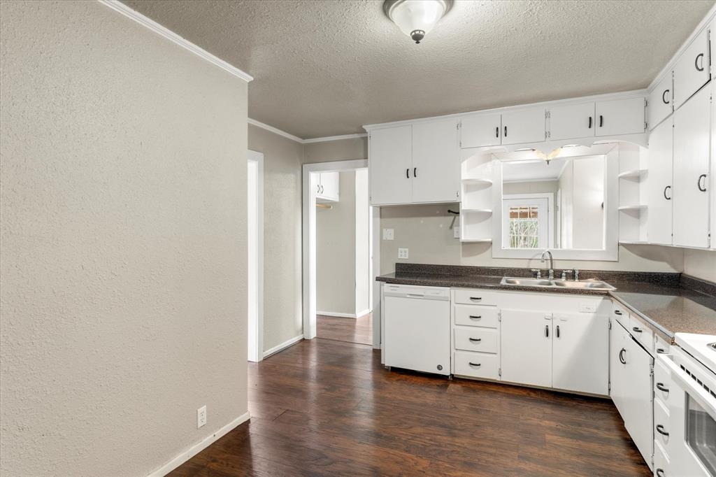 714 Jeanell Street Quitman, TX 75783 - Photo 7 of 20 a large kitchen with granite countertop a white stove top oven and sink