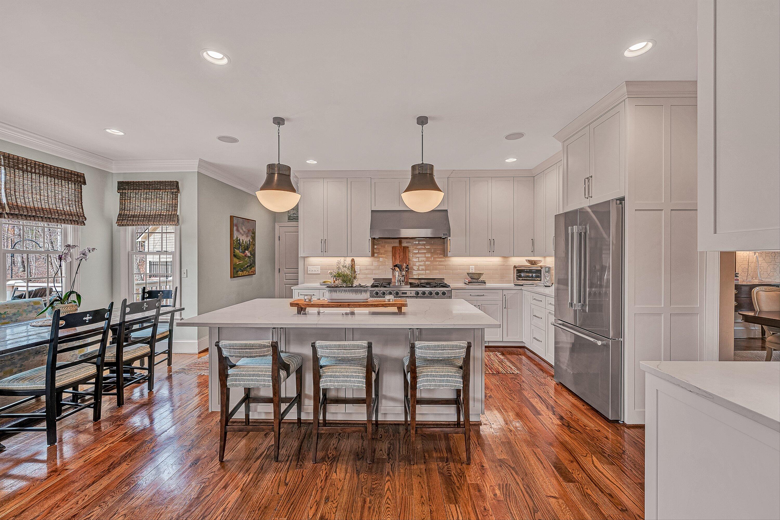 5464 Ridgelea Estates Drive Roanoke, VA 24018 - Photo 29 of 85 a kitchen with stainless steel appliances a dining table chairs stove refrigerator and cabinets