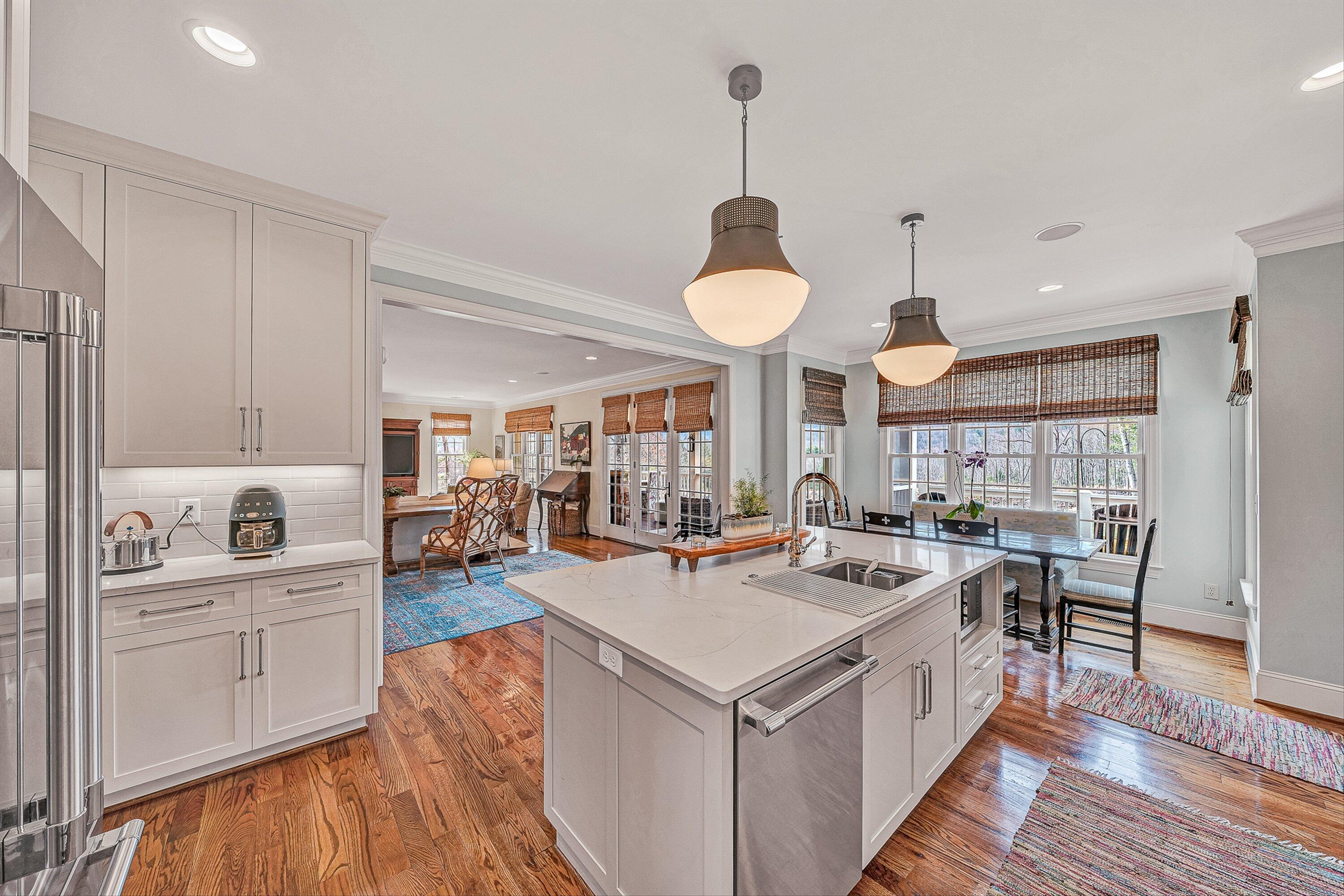 5464 Ridgelea Estates Drive Roanoke, VA 24018 - Photo 33 of 85 a room with stainless steel appliances a stove a sink a dining table and chairs with wooden floor
