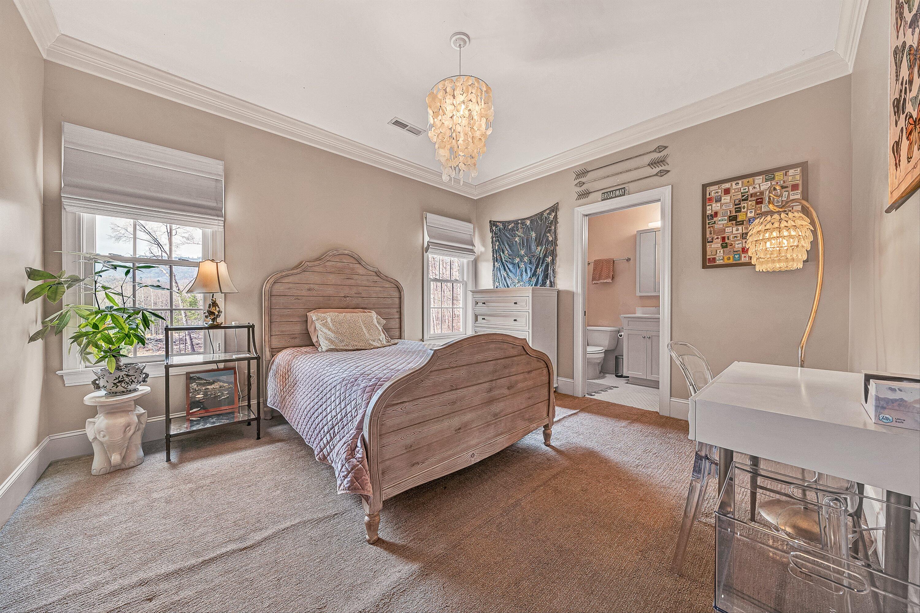 5464 Ridgelea Estates Drive Roanoke, VA 24018 - Photo 62 of 85 a bedroom with a bed and a chandelier