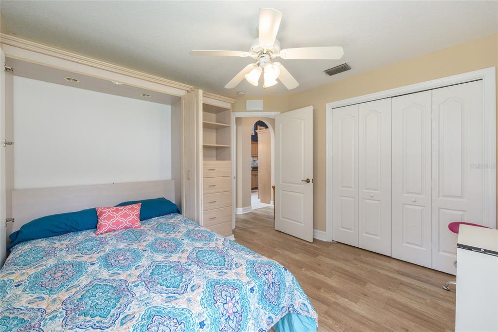 18825 Southwest 93rd Loop Dunnellon, FL 34432 - Photo 34 of 85 a bedroom with a bed and a chandelier
