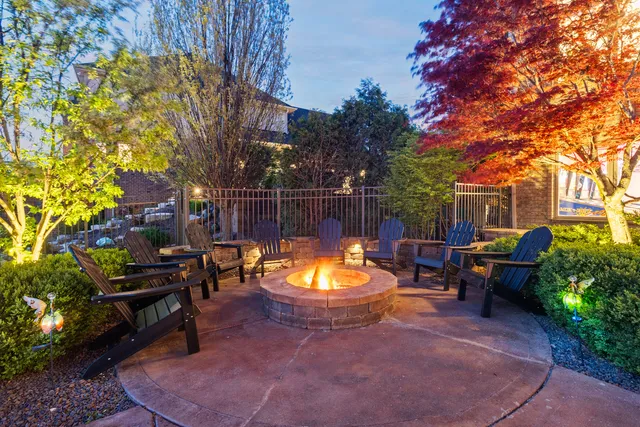an aerial view of residential houses with outdoor space and trees