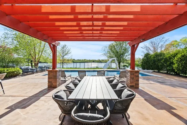 a living room with furniture a potted plant and a large window