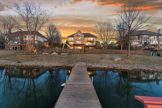 a kitchen with kitchen island granite countertop white cabinets and stainless steel appliances