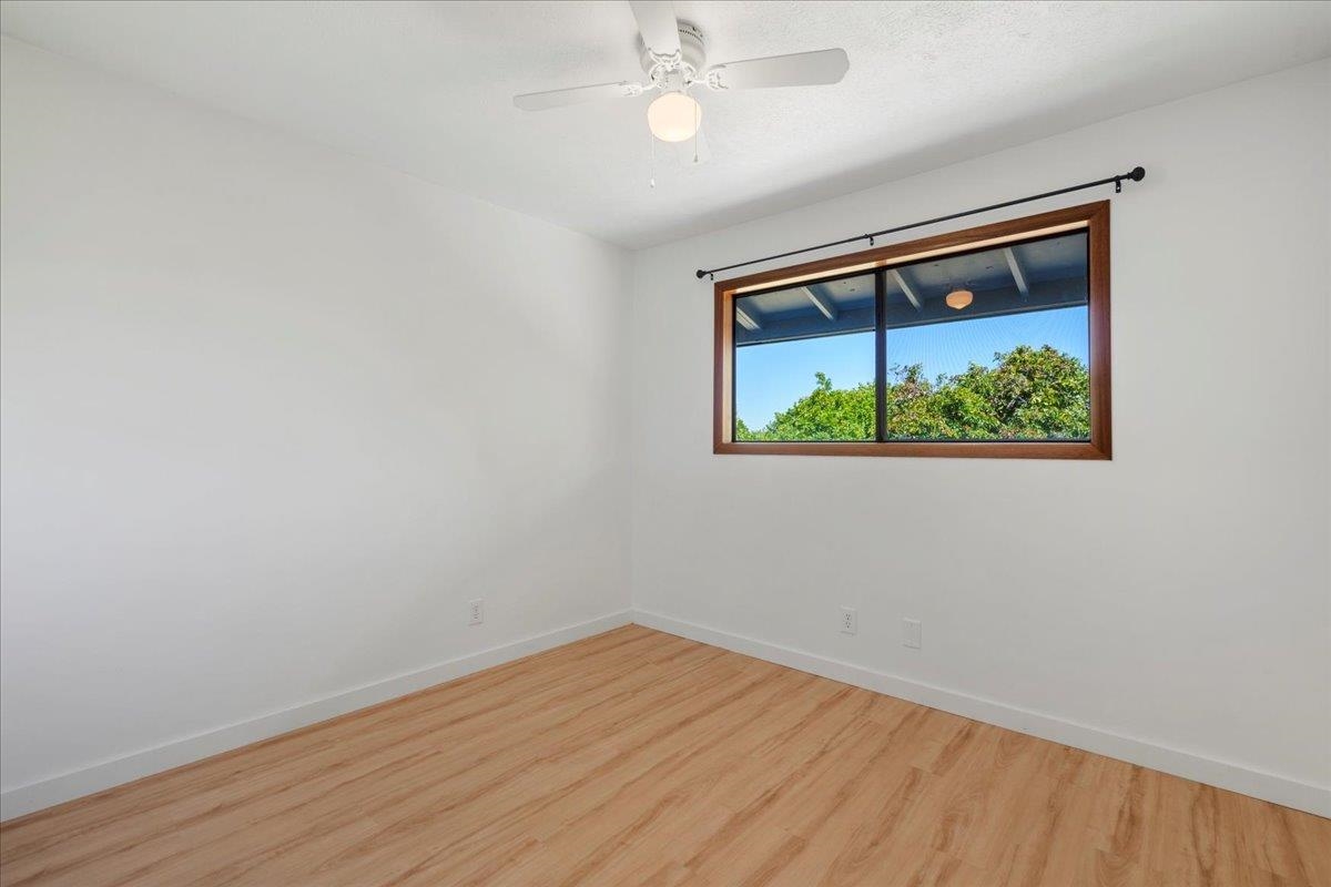2130 Kauhikoa Road, Unit A Haiku, HI 96708 - Photo 27 of 43 an empty room with a window and ceiling fan