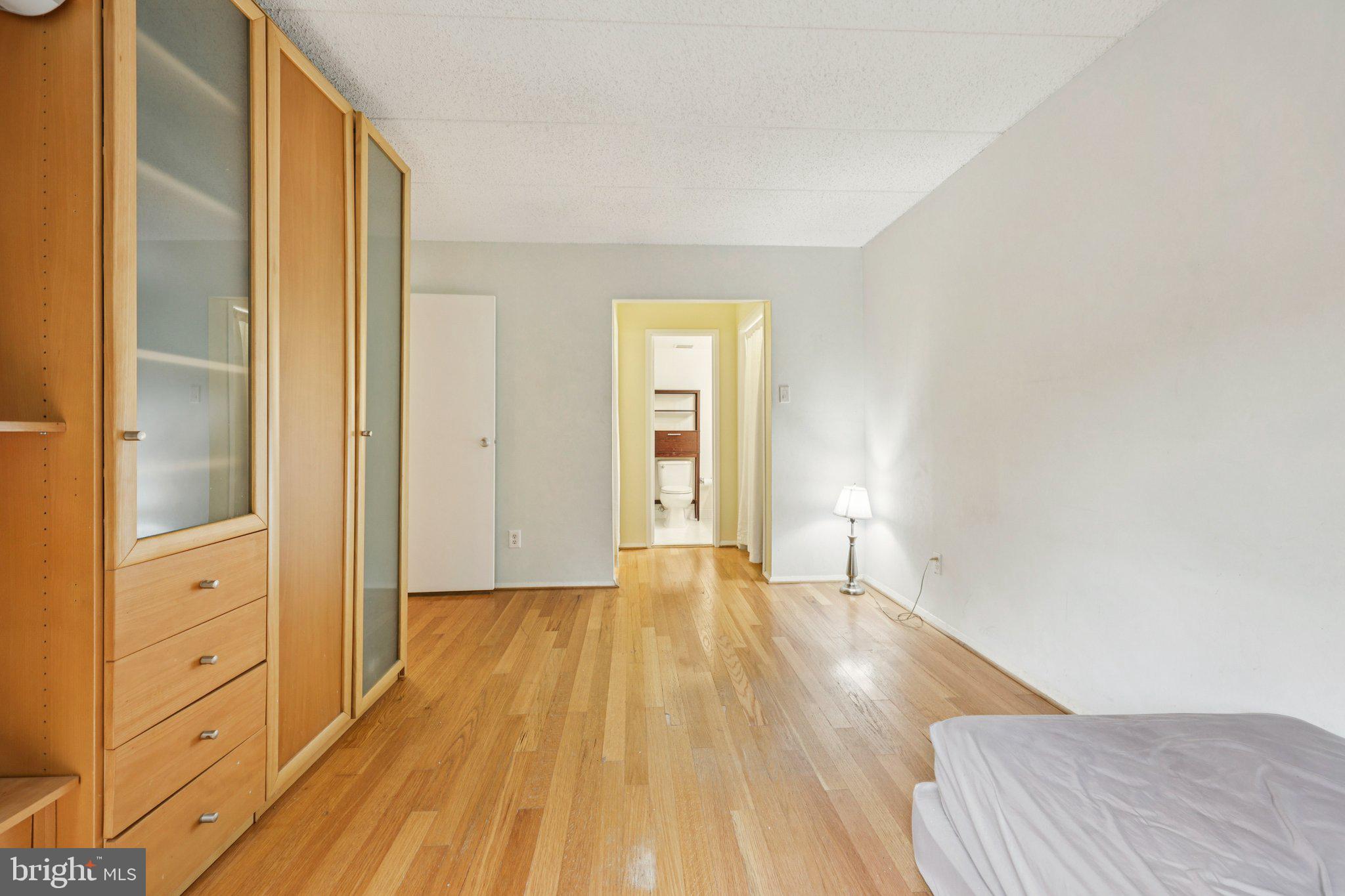 2118 Green Watch Way, Unit 10/201C Reston, VA 20191 - Photo 13 of 30 a view of an empty room with wooden floor and a window