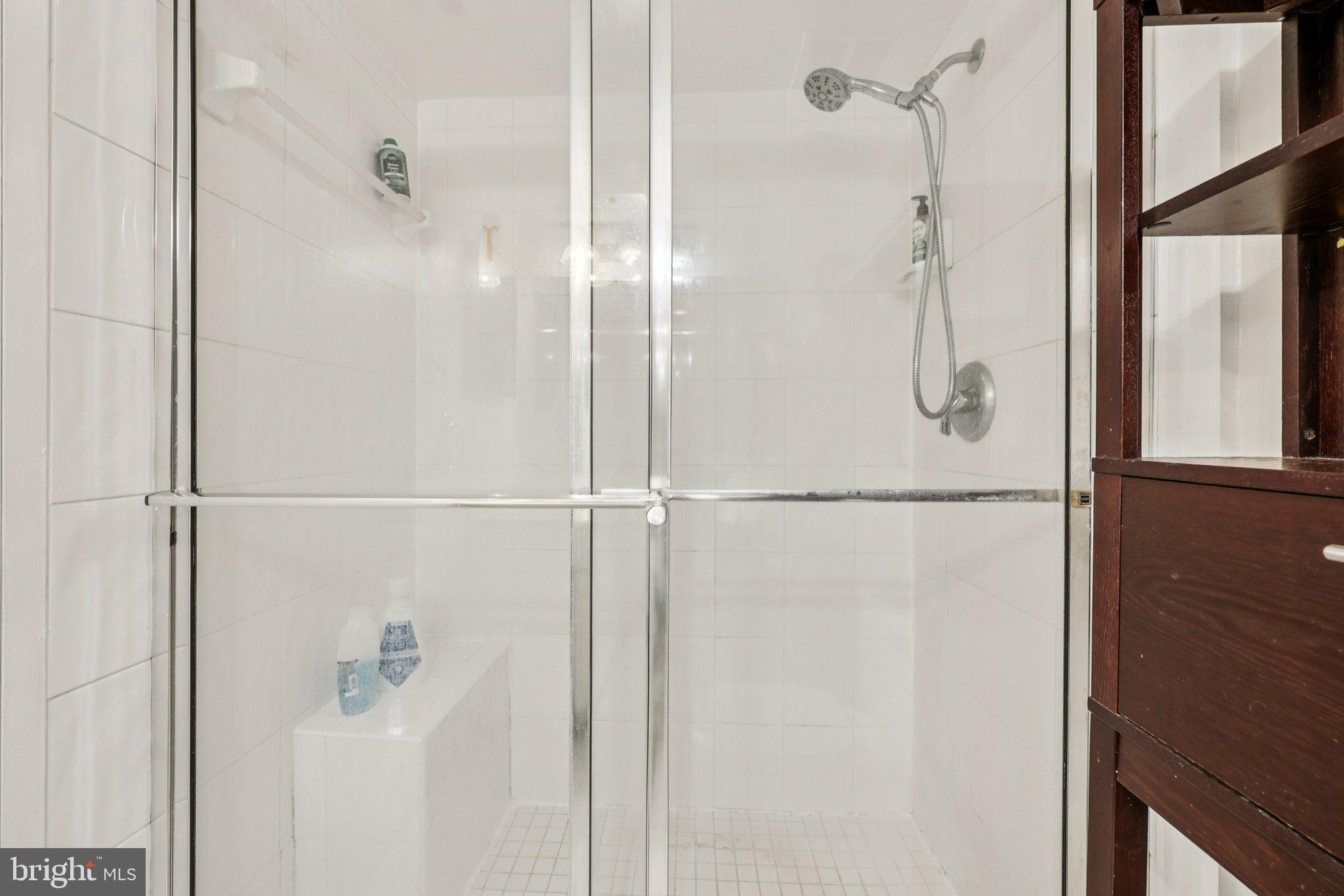 2118 Green Watch Way, Unit 10/201C Reston, VA 20191 - Photo 17 of 30 a bathroom with a glass shower door