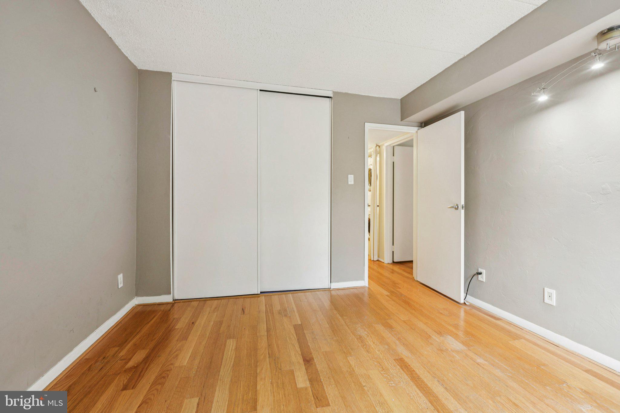 2118 Green Watch Way, Unit 10/201C Reston, VA 20191 - Photo 19 of 30 a view of an empty room with wooden floor