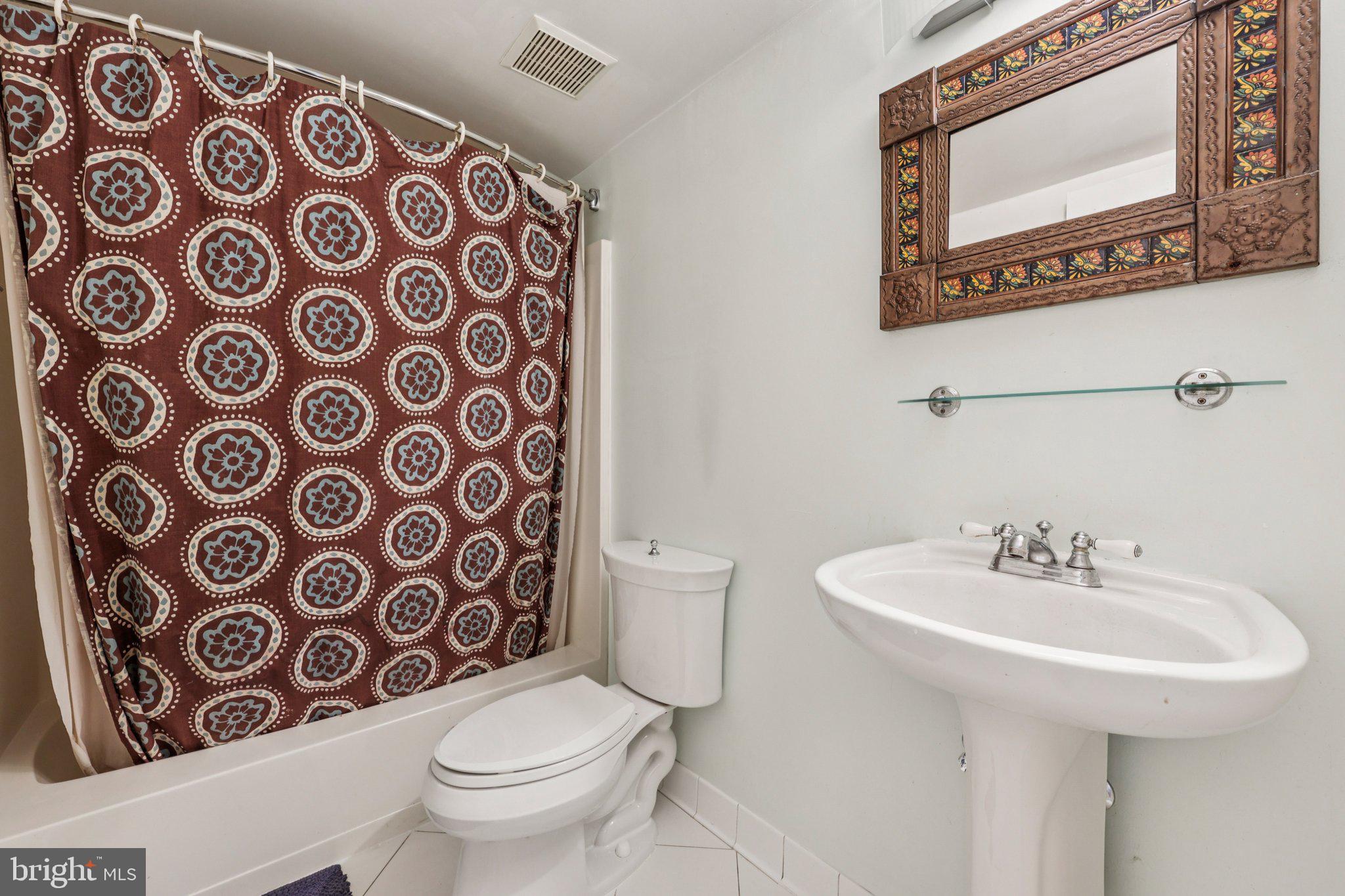 2118 Green Watch Way, Unit 10/201C Reston, VA 20191 - Photo 20 of 30 a bathroom with a toilet sink and a mirror