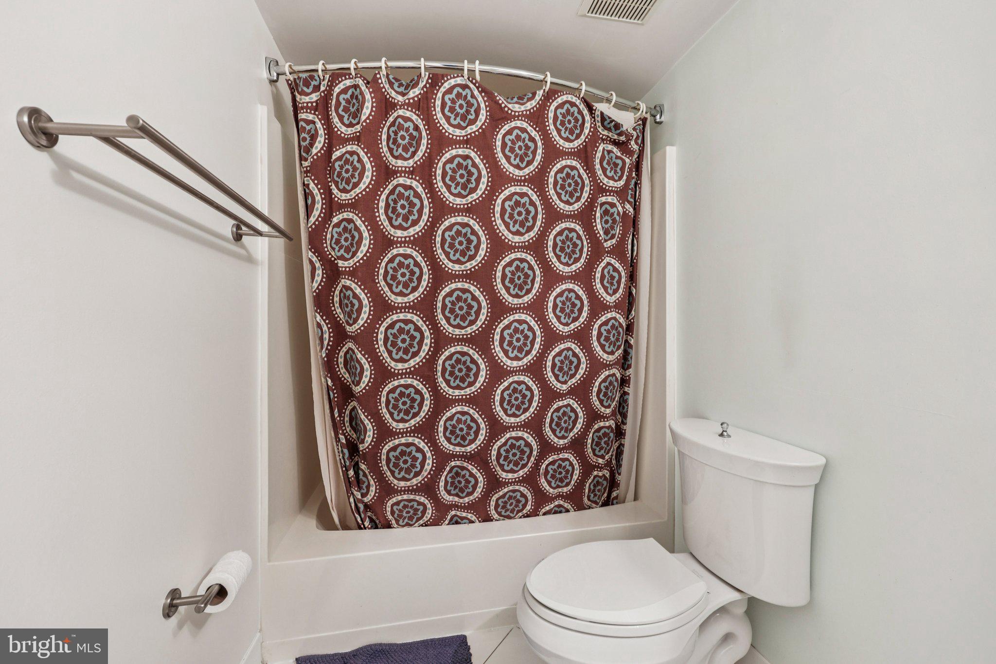 2118 Green Watch Way, Unit 10/201C Reston, VA 20191 - Photo 21 of 30 a white toilet sitting next to a shower curtain