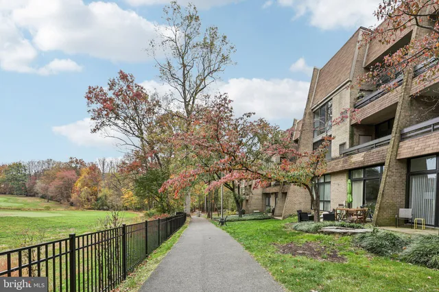 a front view of a residential apartment building with a yard
