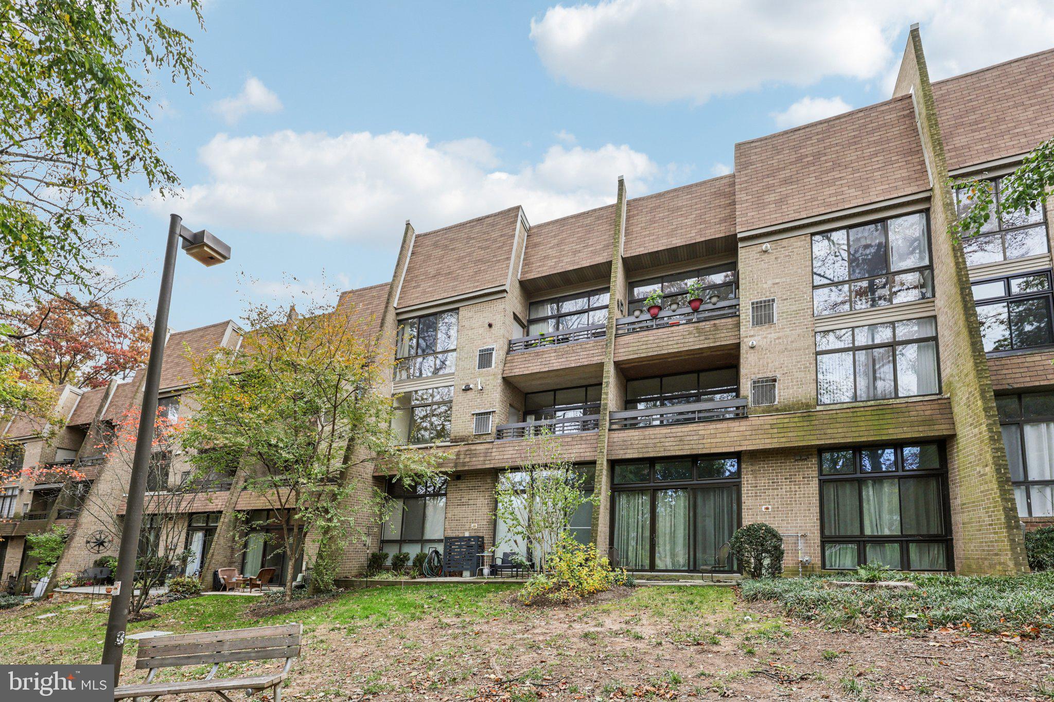 2118 Green Watch Way, Unit 10/201C Reston, VA 20191 - Photo 29 of 30 a front view of a residential apartment building with a yard