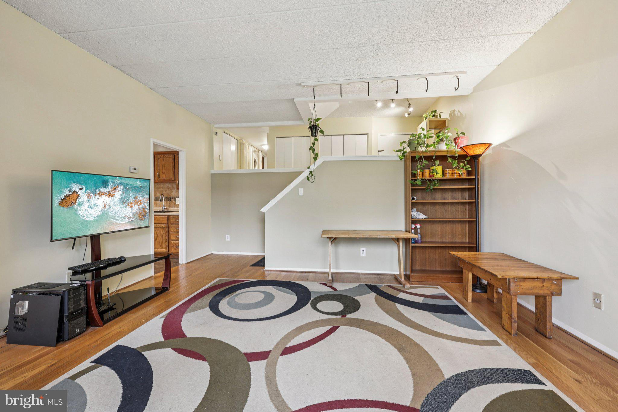 2118 Green Watch Way, Unit 10/201C Reston, VA 20191 - Photo 3 of 30 a bedroom with furniture and a flat screen tv