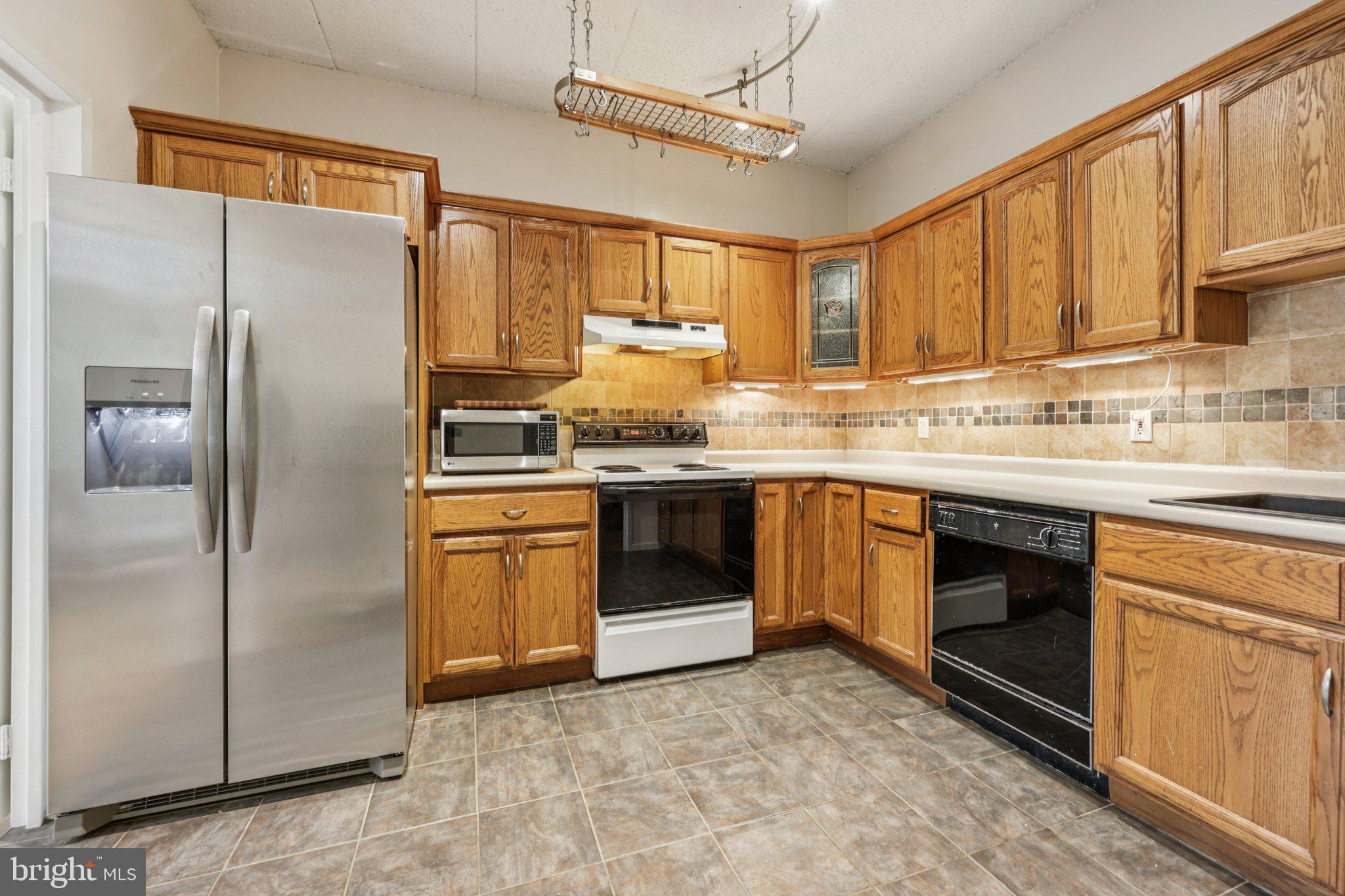 2118 Green Watch Way, Unit 10/201C Reston, VA 20191 - Photo 9 of 30 a kitchen with stainless steel appliances granite countertop a refrigerator and a sink