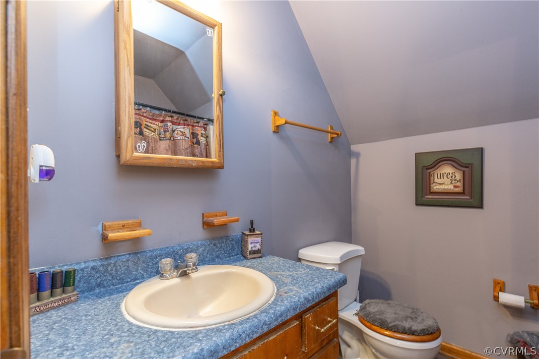 16190 Glebe Road Dewitt, VA 23840 - Photo 29 of 42 a bathroom with a toilet a sink and mirror