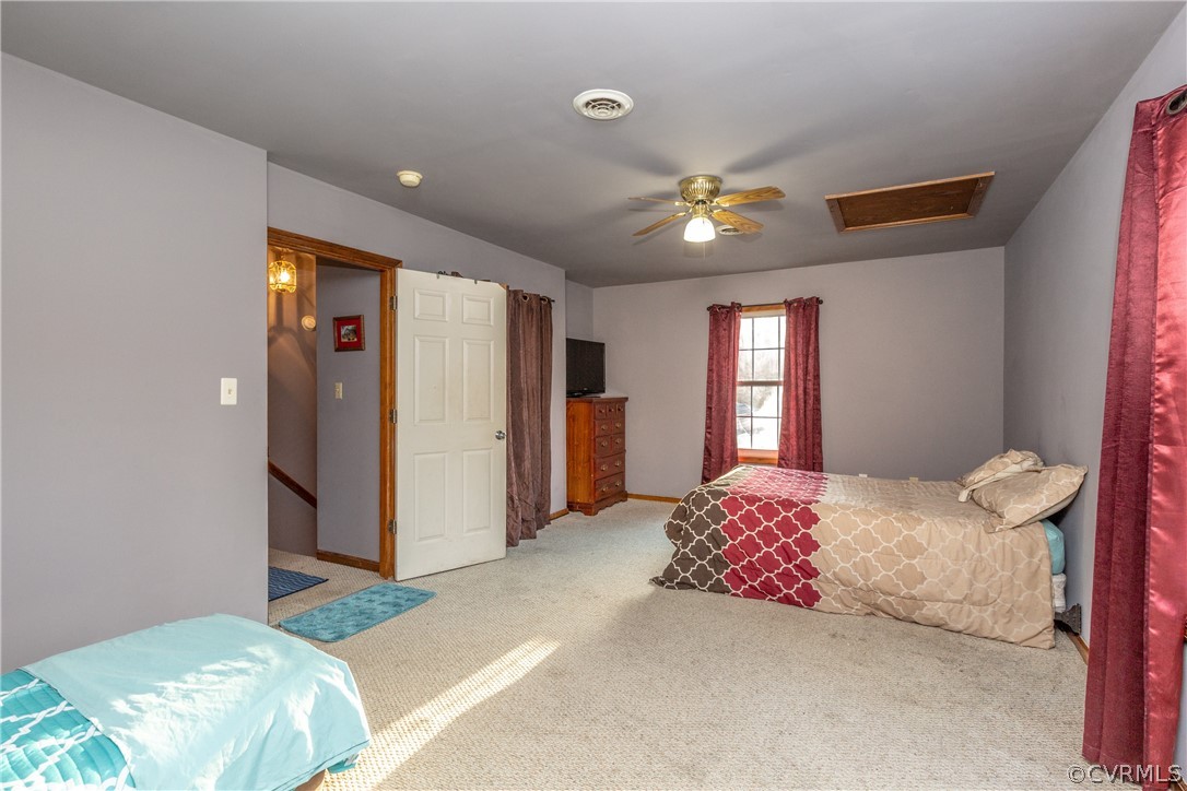 16190 Glebe Road Dewitt, VA 23840 - Photo 34 of 42 a bedroom with a bed and a chandelier
