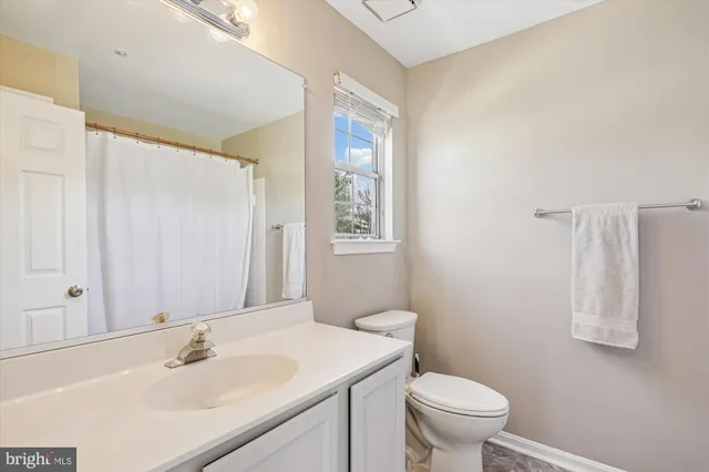 a bathroom with a sink toilet and vanity