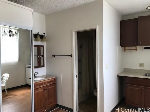 a view of kitchen with cabinets and window
