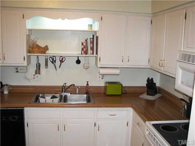 641 Pine Ridge Place Raleigh, NC 27609 - Photo 14 of 25 a kitchen with a sink dishwasher and cabinets