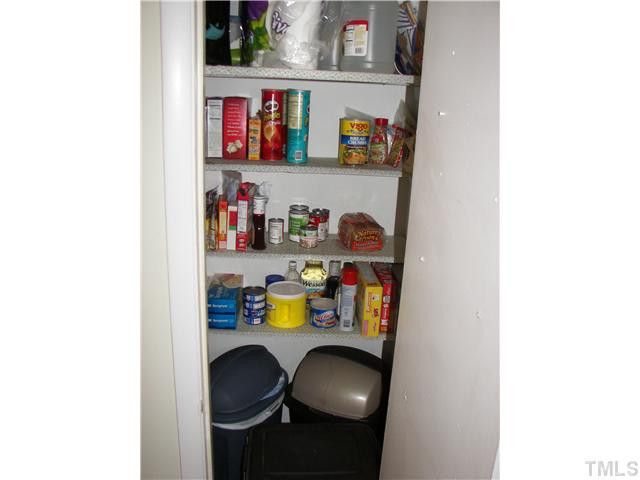 641 Pine Ridge Place Raleigh, NC 27609 - Photo 15 of 25 a shelf with dining room and cabinets