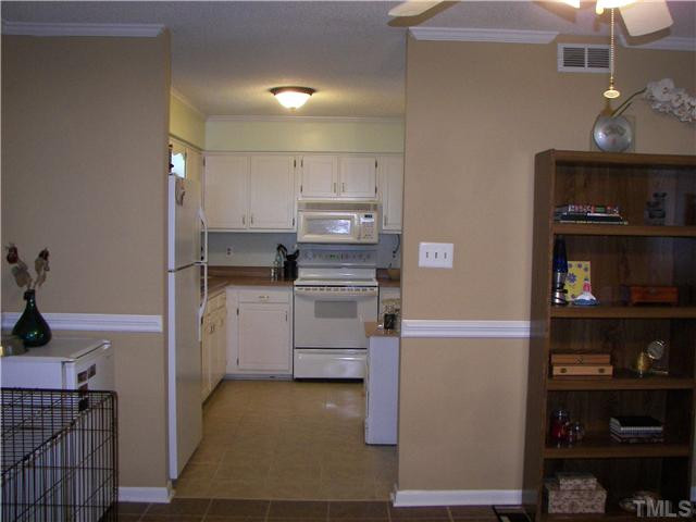 641 Pine Ridge Place Raleigh, NC 27609 - Photo 5 of 25 a kitchen with cabinets and window