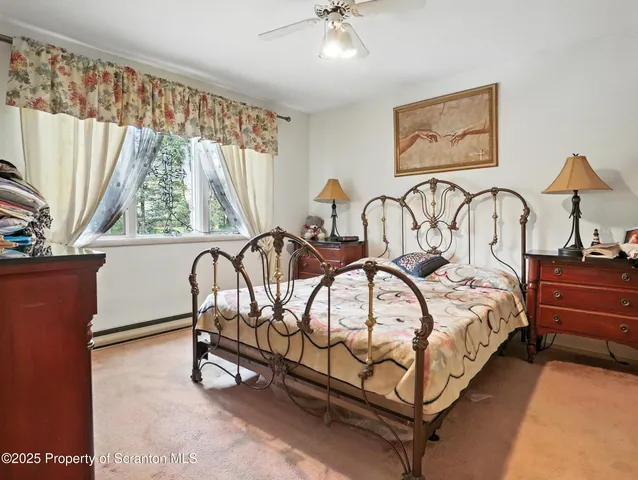 a bedroom with bed and a chandelier