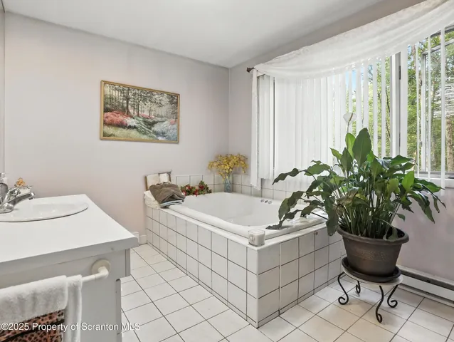 a white bath tub sitting in a bathroom next to a white tub