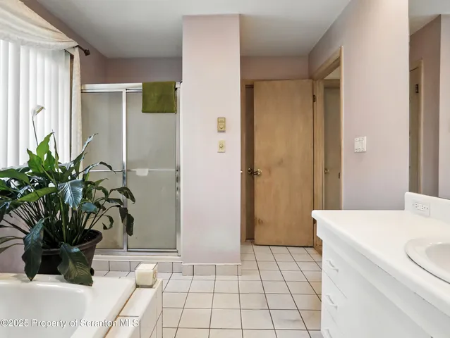 a room with a door and a potted plant