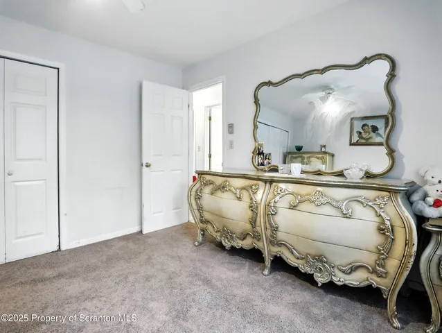 a bedroom with bed and a mirror