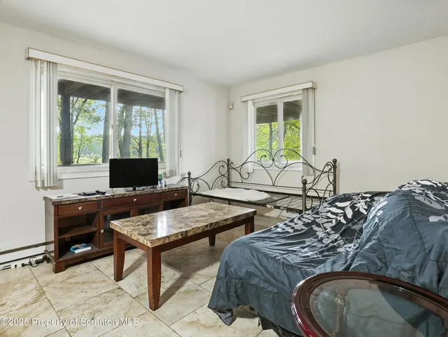 a view of a livingroom with workspace and a window