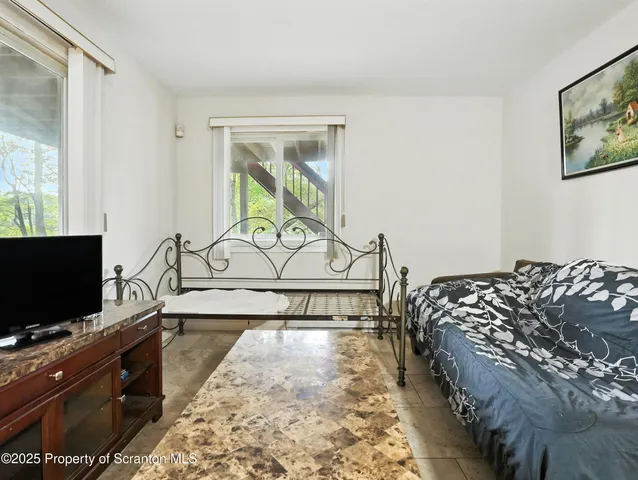 a bedroom with bed and flat screen tv