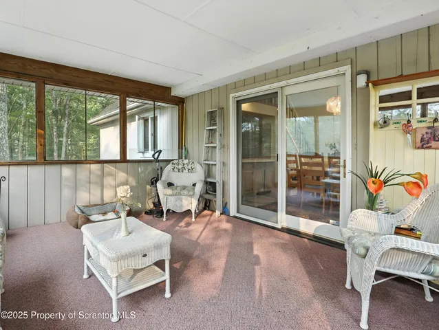 a living room with furniture a rug and a large window
