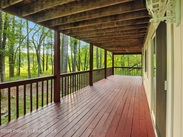 a view of porch with wooden floor