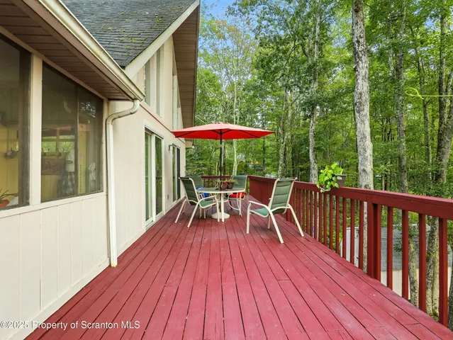 a view of balcony with chairs and wooden floor