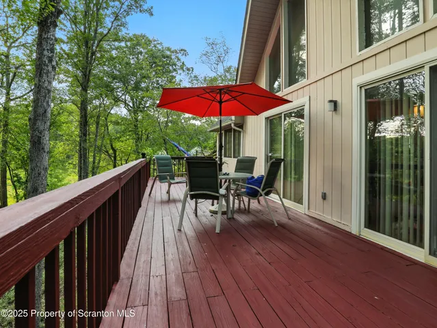 a view of balcony with furniture and wooden deck