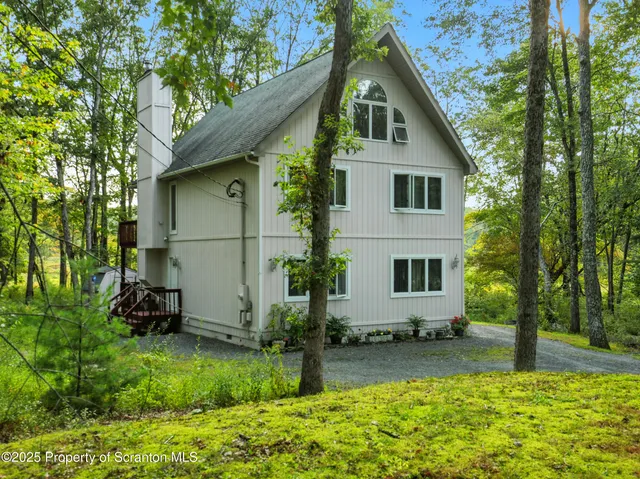 a front view of house with a garden