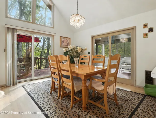 a view of a dining room with furniture wooden floor and a chandelier