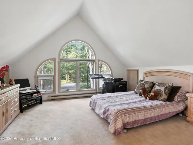 a bedroom with a bed and a large window