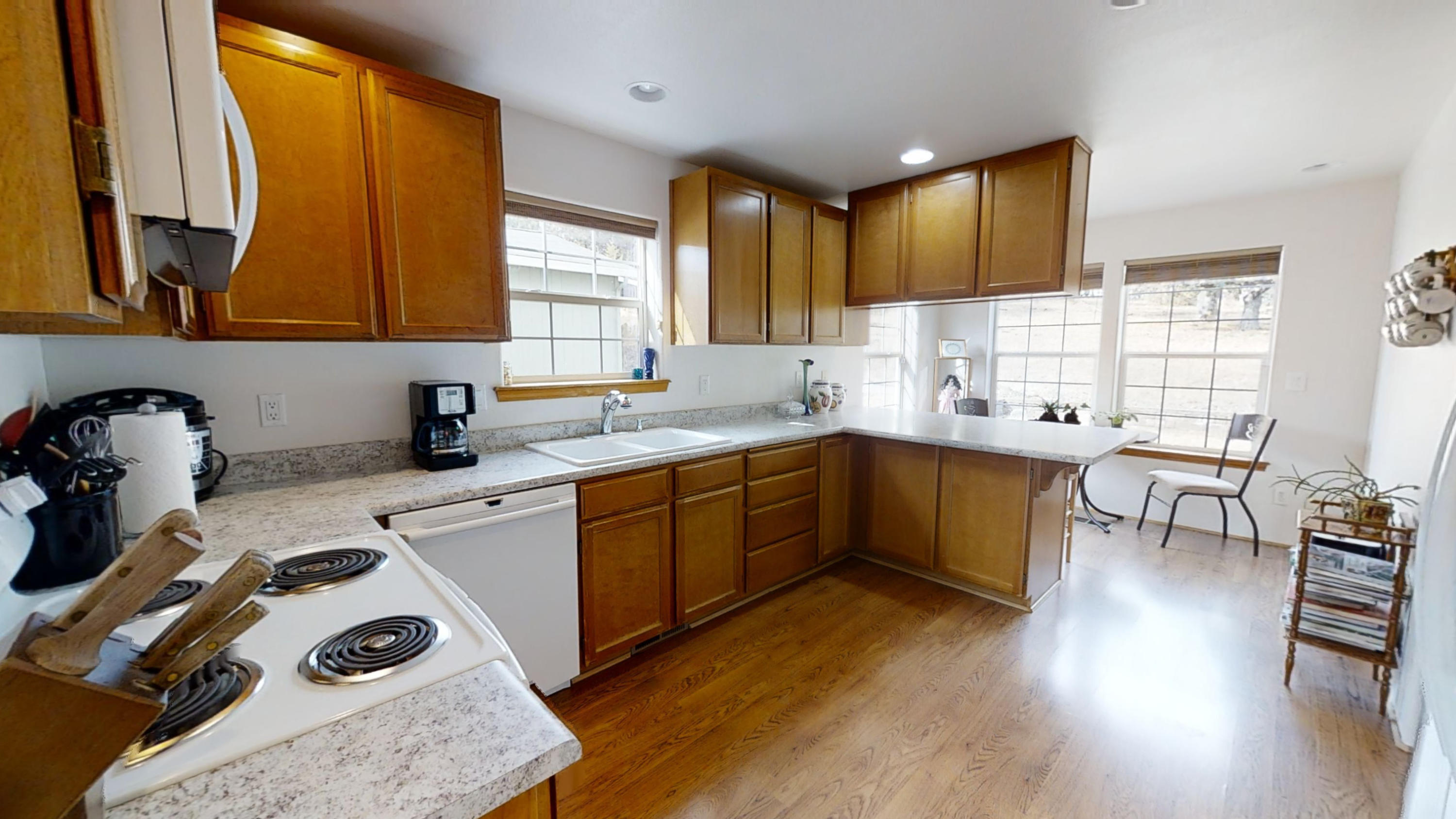1023 Bigham Brown Road Eagle Point, OR 97524 - Photo 12 of 52 a kitchen with a sink a stove a refrigerator and wooden floor