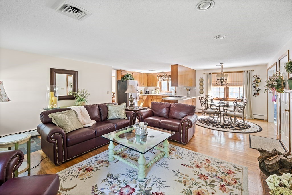 111 Seth Parker Road Barnstable, MA 02632 - Photo 5 of 27 a living room with furniture a rug and a chandelier