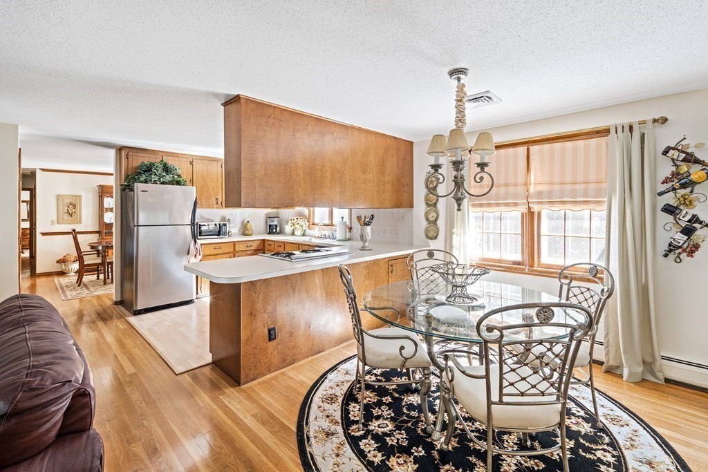 111 Seth Parker Road Barnstable, MA 02632 - Photo 6 of 27 a living room with furniture a chandelier and a dining table