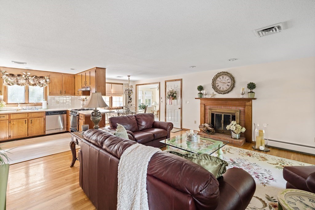 111 Seth Parker Road Barnstable, MA 02632 - Photo 8 of 27 a living room with furniture a large window and a fireplace