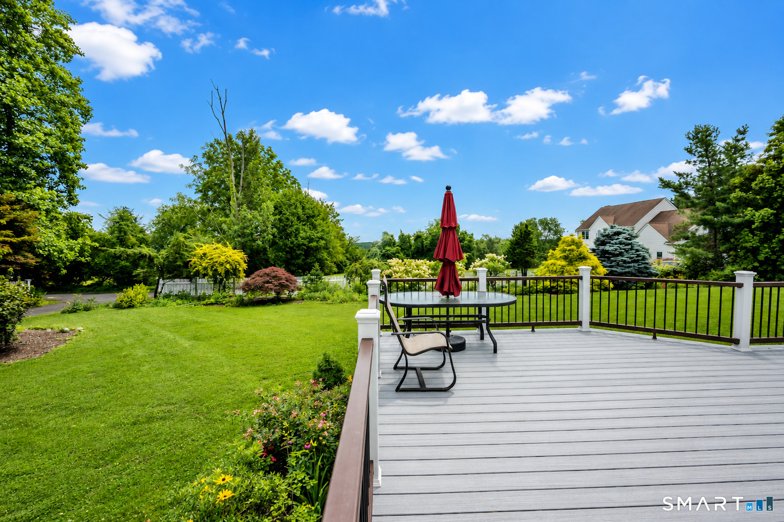 35 Anderson Lane Durham, CT 06422 - Photo 22 of 25 Expansive composite deck overlooking a beautifully landscaped backyard-perfect for outdoor dining, entertaining, or simply relaxing while enjoying the peaceful views.